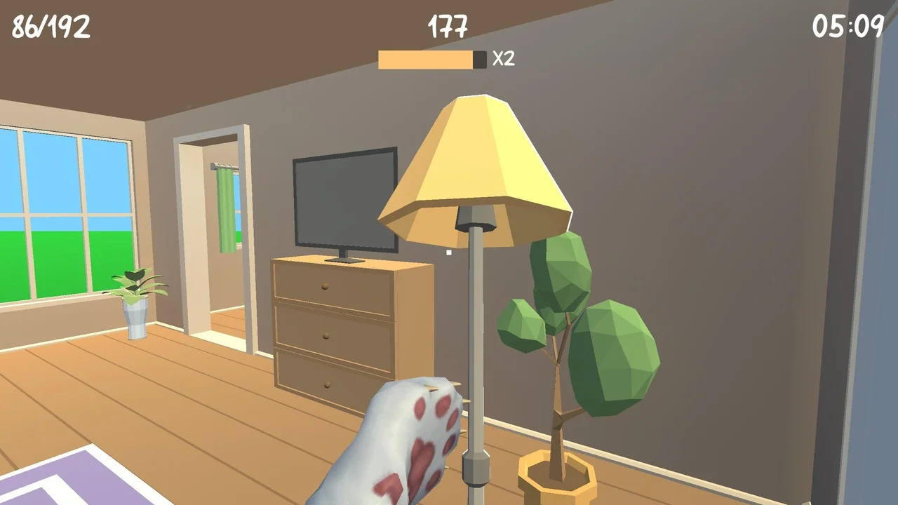 猫の手が映るゲーム画面で、部屋に置かれた黄色いランプと観葉植物